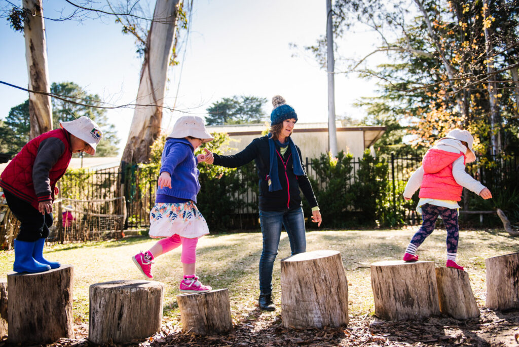 KU Bilya Gulyangarri childcare educator supervising children playing outdoors