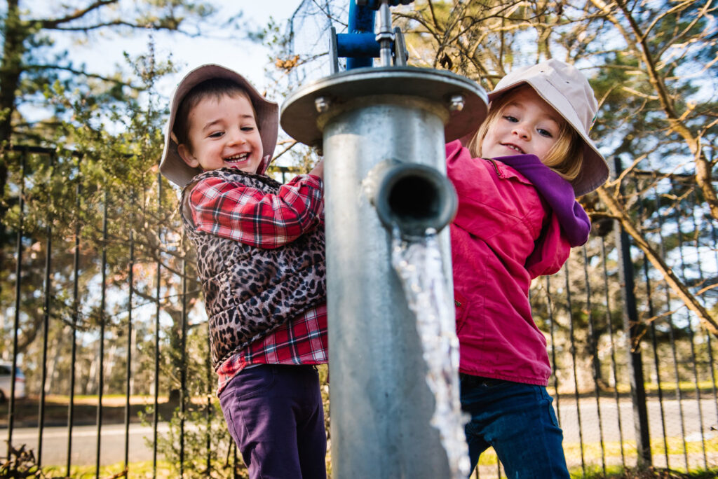 Children playing with a water feature at KU Bilya Gulyangarri childcare