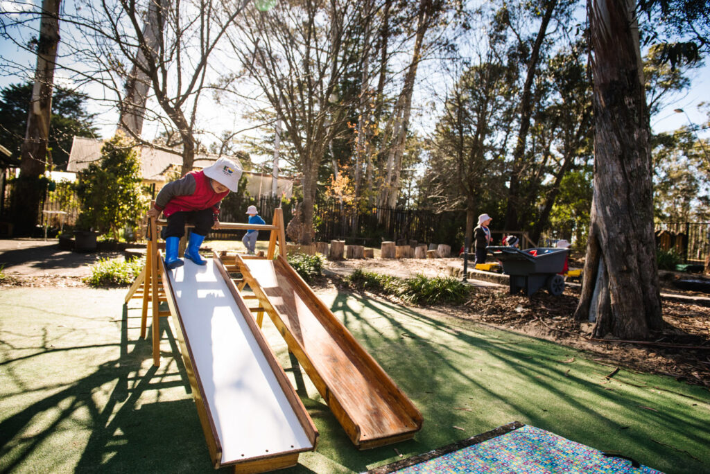 Child playing on the slide at KU Bilya Gulyangarri childcare