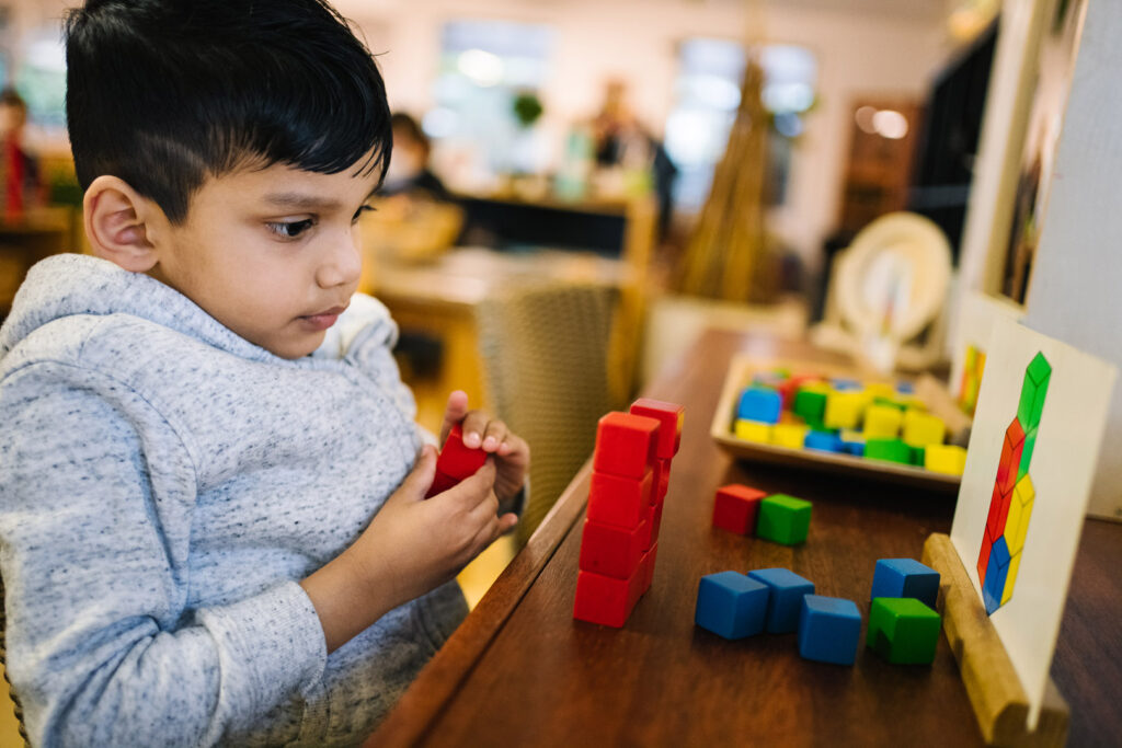 Child playing with blocks at KU Bligh Park childcare