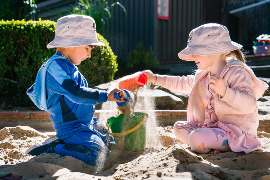 Children playing in the sand at KU Greenwood childcare