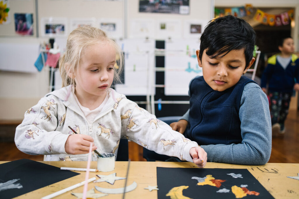 Children doing a painting at KU Greenwood childcare