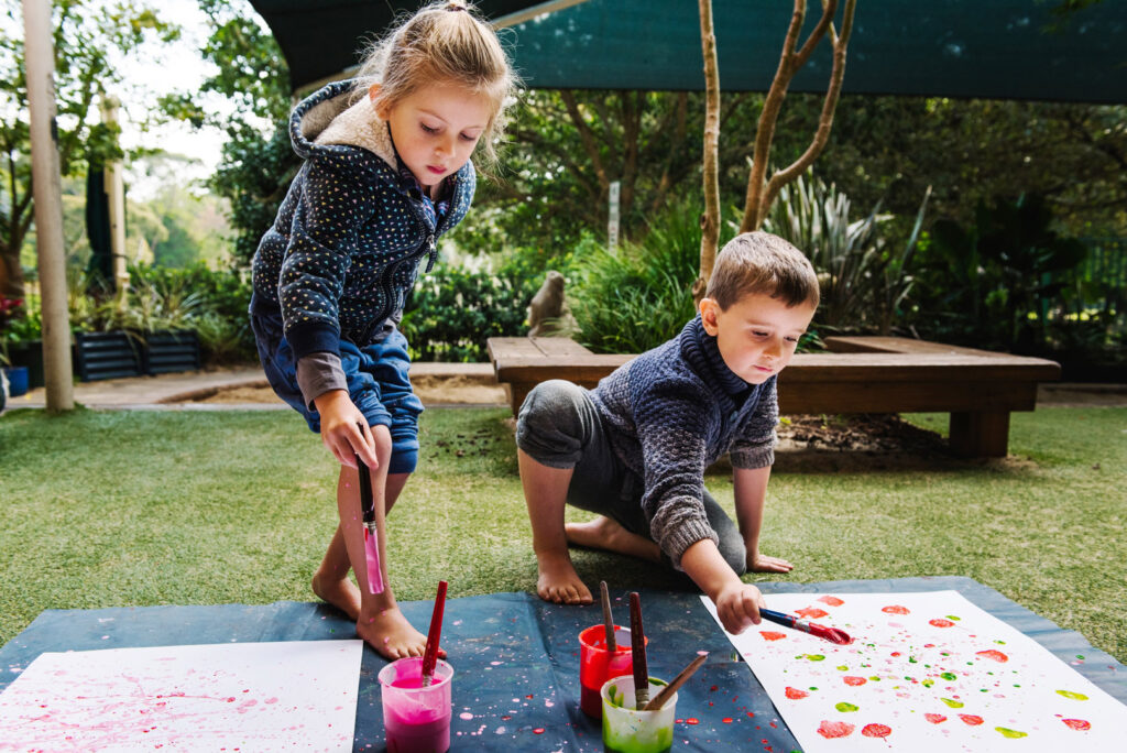 Children painting at KU Grandstand childcare