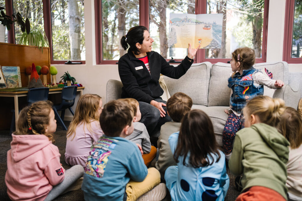 KU Peter Pan Paddington childcare educator reading a story to children