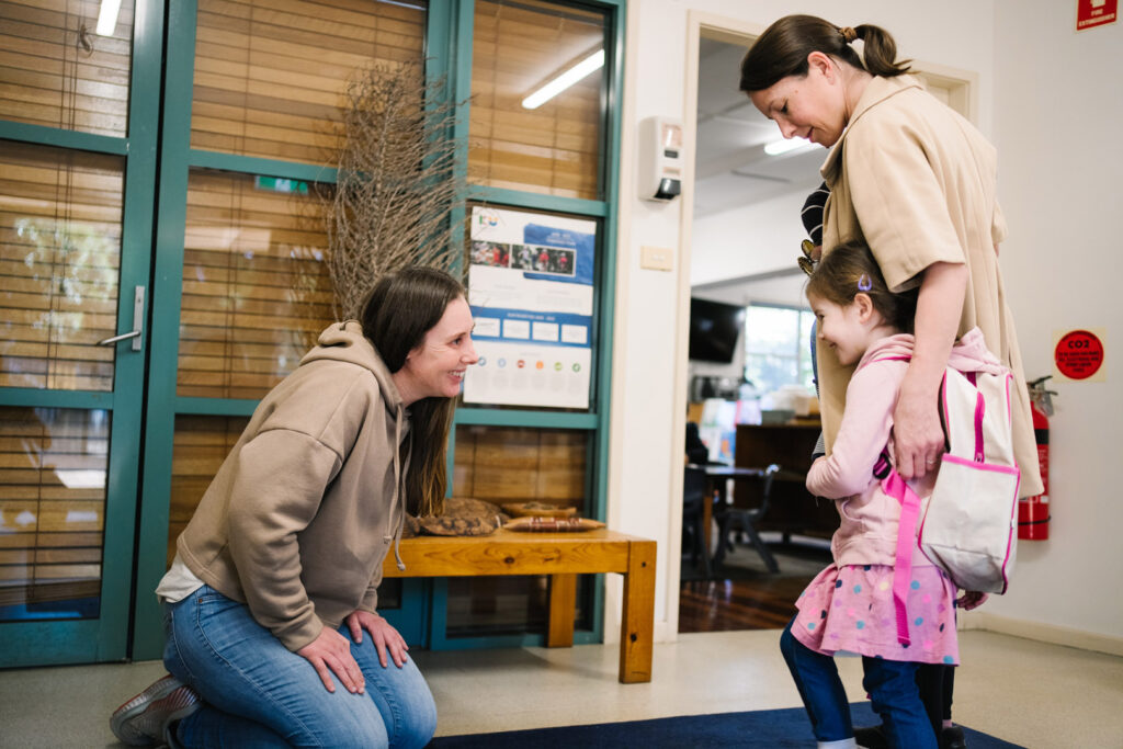 KU Peter Pan Paddington childcare educator greeting a family