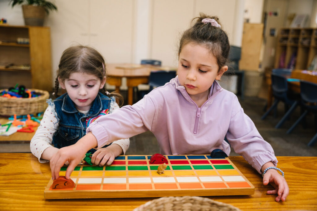 Children playing a board game at KU Peter Pan Paddington childcare