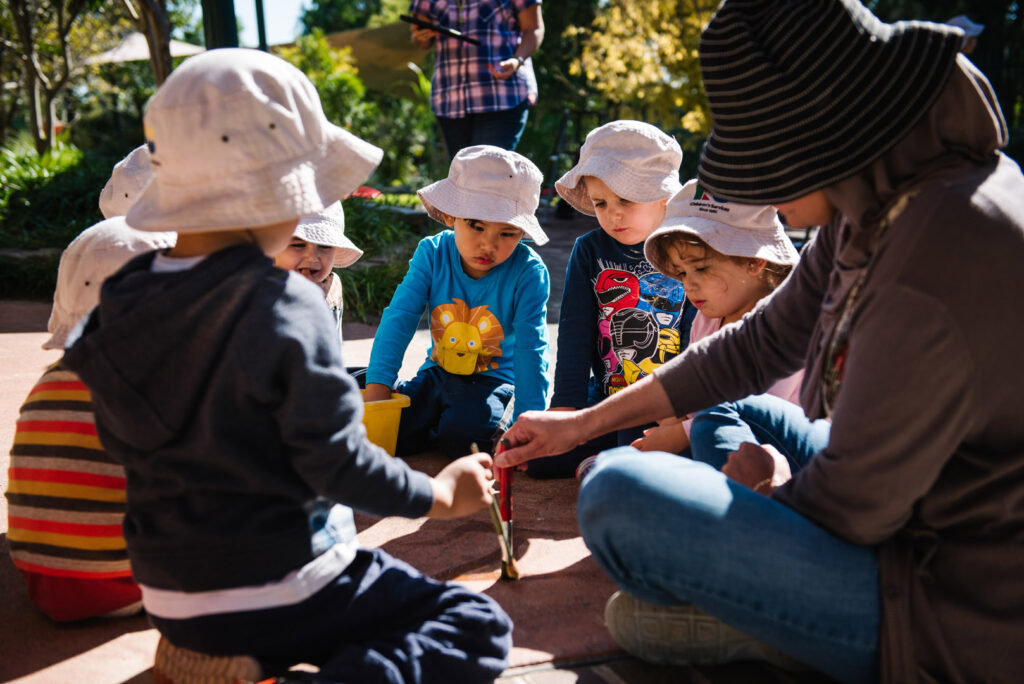 KU Playford Park childcare educator and children sitting in a circle