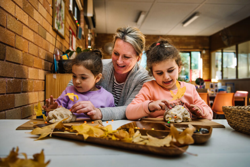 KU Padstow childcare educator and children sculpting with playdough