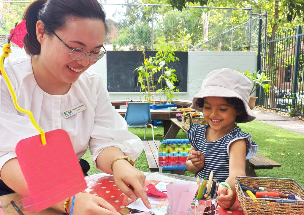 KU Maybanke childcare educator doing arts and crafts with a child