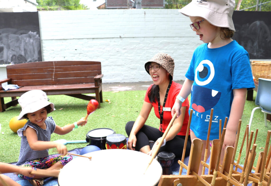 KU Maybanke childcare and children making music