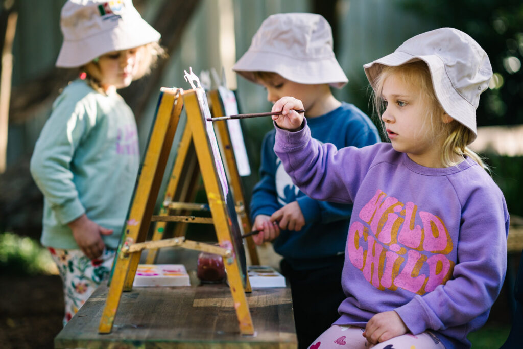 Children doing some painting at KU The Chase childcare