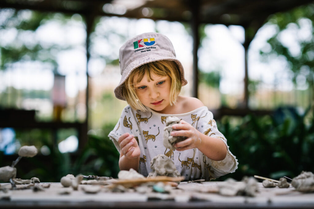 Child sculpting with clay at KU Rushcutters Bay childcare