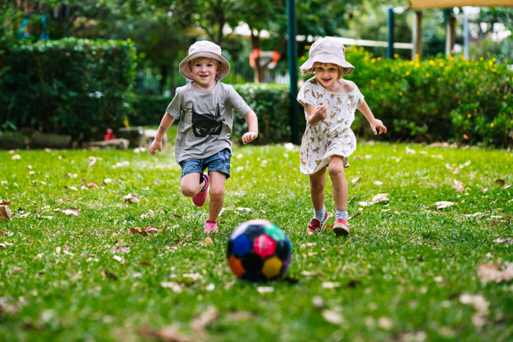 Children kicking a ball at KU Rushcutters Bay childcare