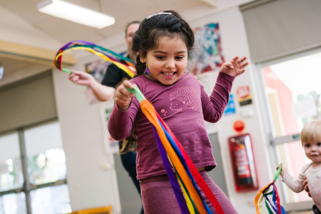 Child playing with a ribbon at KU NSP Shortland Public School childcare