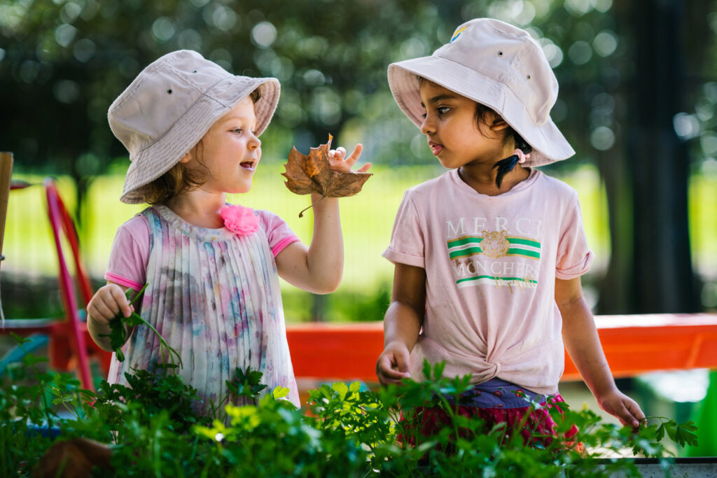 Children looking at plants in the garden at KU Phillip Park childcare