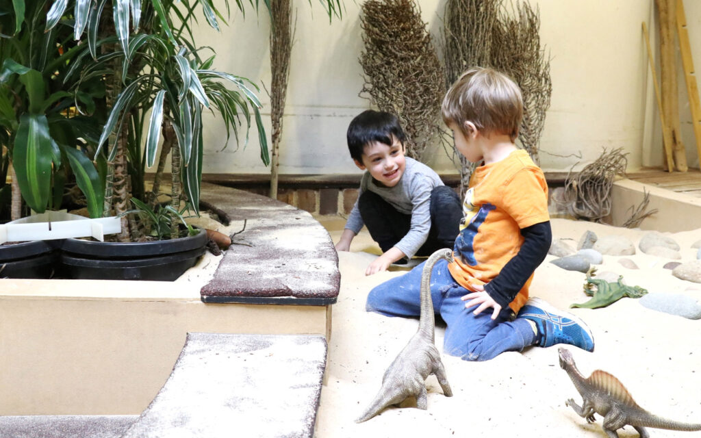 Children playing in the sand at KU's The Tree House childcare