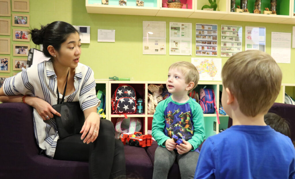 KU's The Tree House childcare educator interacting with children