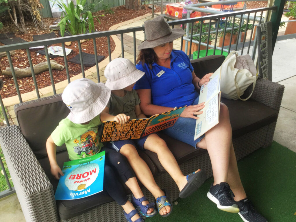 KU Peninsula childcare educator reading stories with children