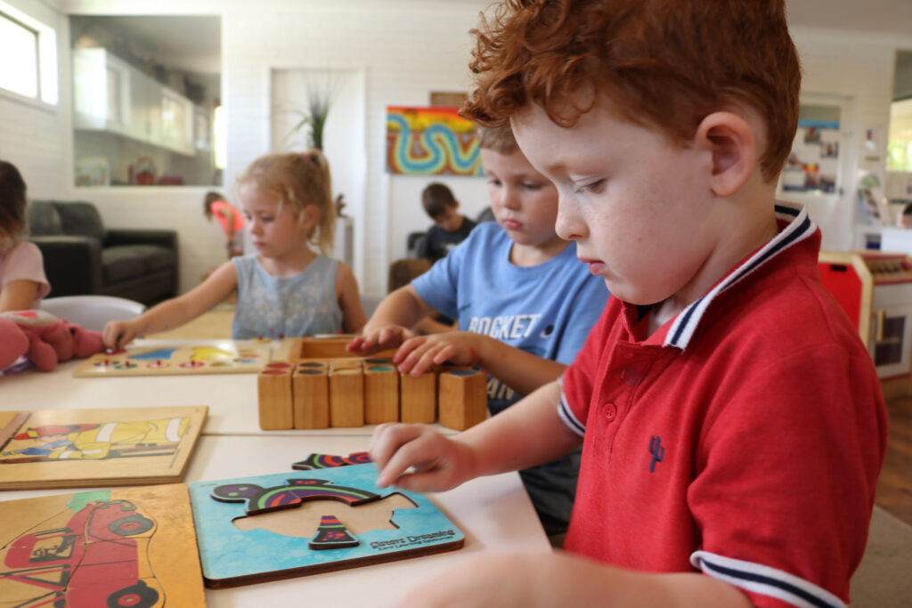 Children doing puzzles at KU Kangaroo childcare