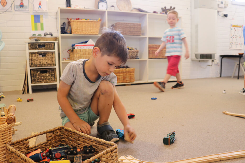 Child playing with trains at KU Kangaroo childcare