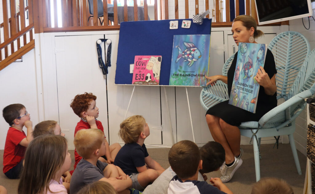 KU Kangaroo childcare educator reading a story to children