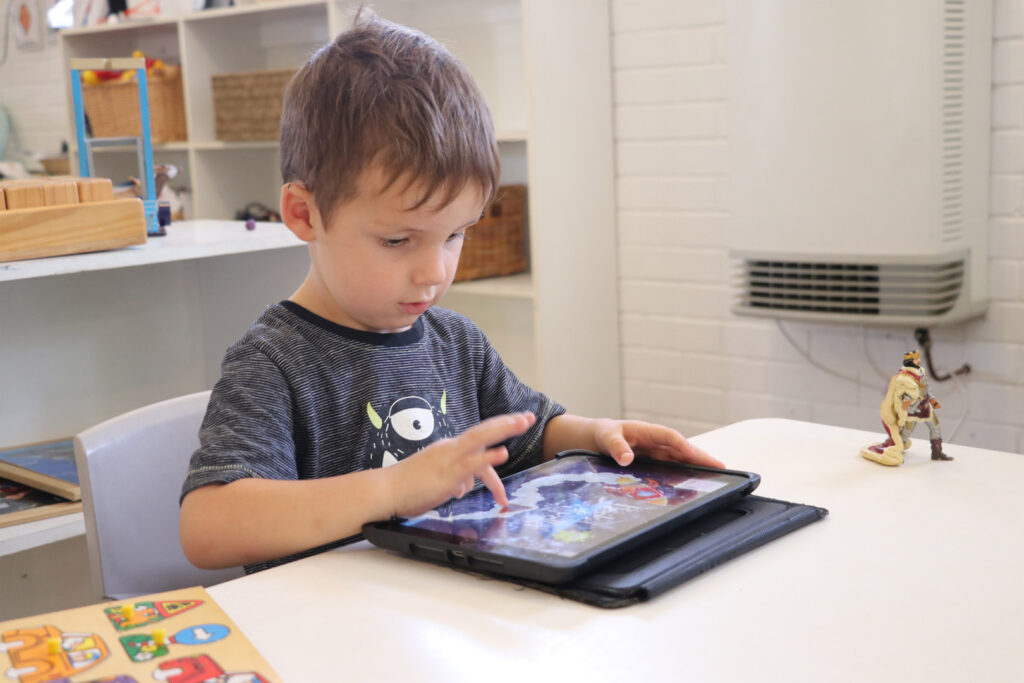 Child with a learning device at KU Kangaroo childcare