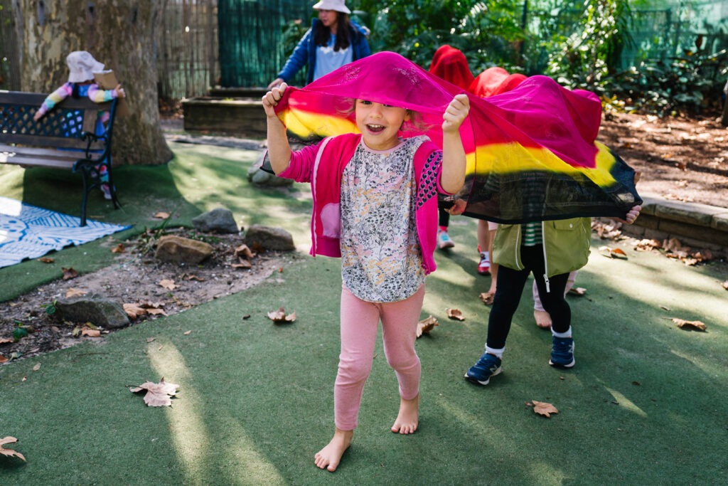 Children playing outdoors at KU James Cahill childcare