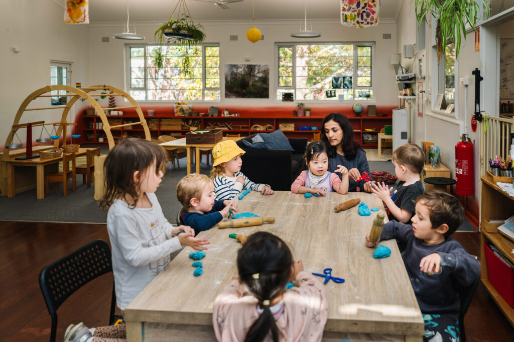 KU James Cahill childcare educator and children sculpting with playdough