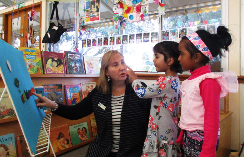 KU Wentworthville childcare educator playing fuzzy felts with children