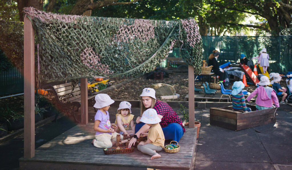 KU Wickham childcare educator supervising children playing outside