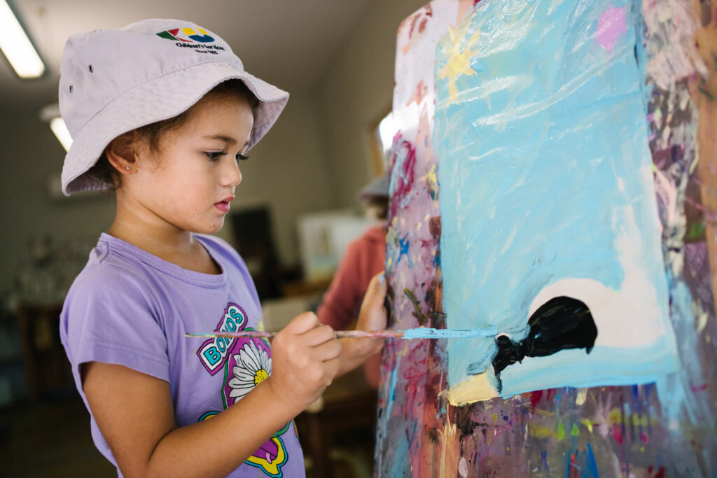 Child painting at KU Wickham childcare