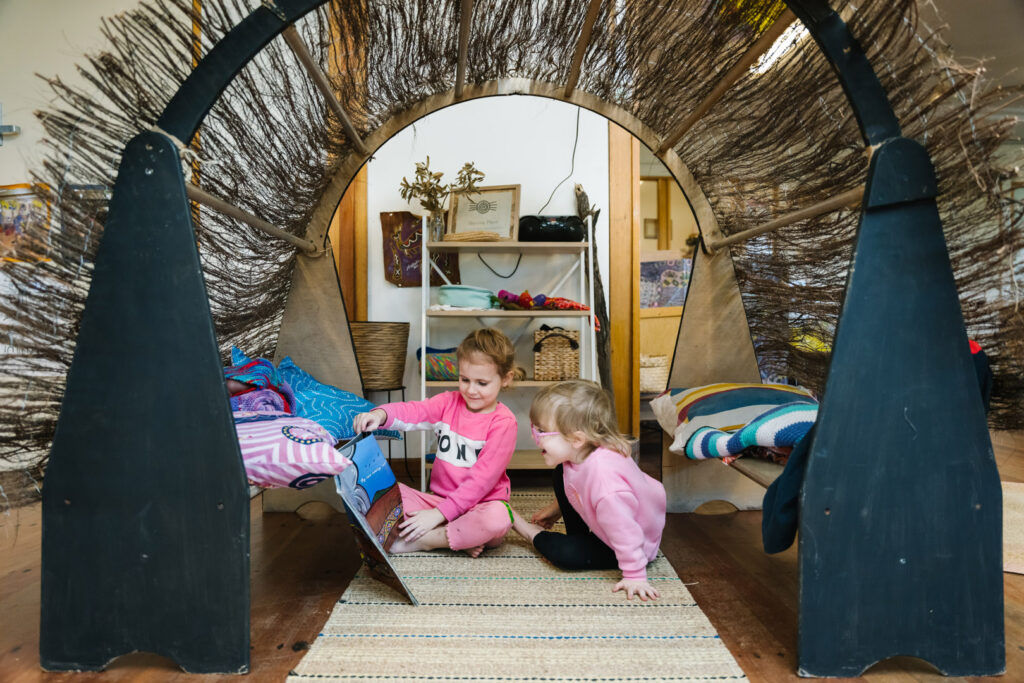 Children reading a story together at KU Windale childcare