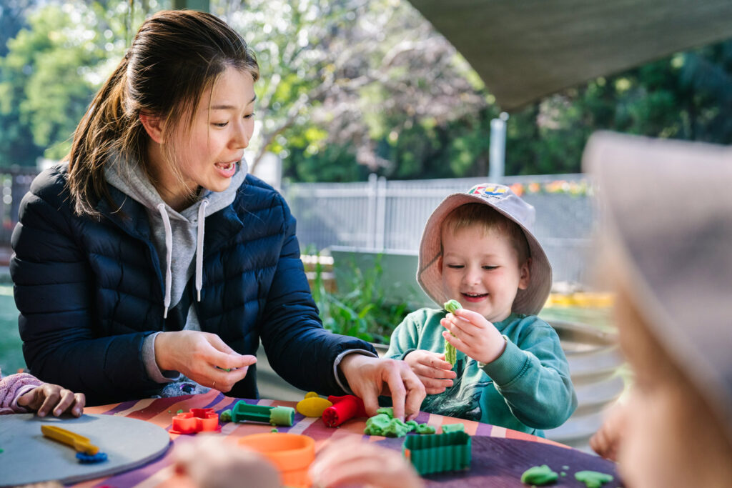 KU Concord educator using playdough with child